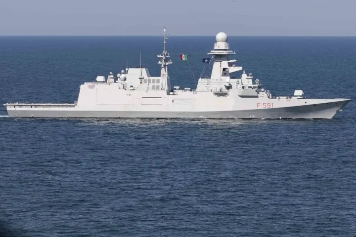 The Italian Navy FREMM frigate Virginio Fasan (F 591) sailing in the Black Sea, seen from the side with the Italian and NATO flags flying