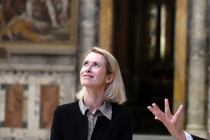 Kaja Kallas looking upwards inside a marble-floored hall of the Vatican