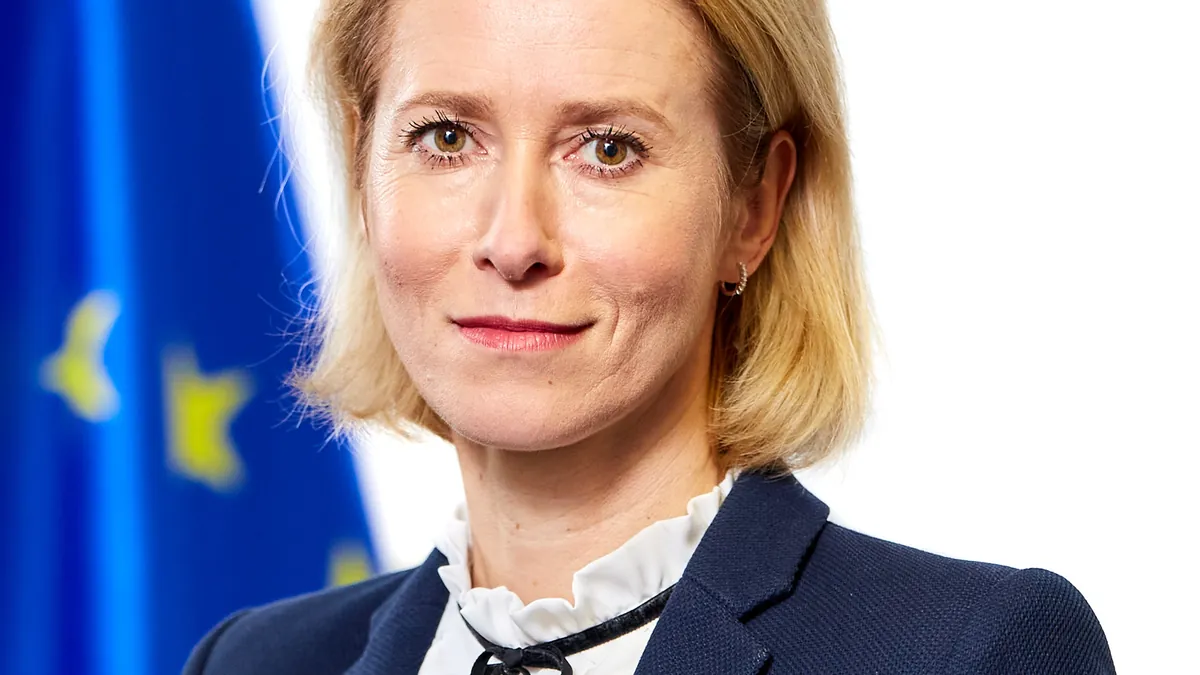 Portrait of EU High Representative Kaja Kallas in front of the EU flag