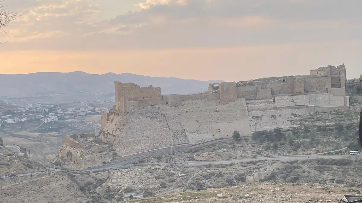 Karak Castle on its hill above the town of Karak in southern Jordan at dusk