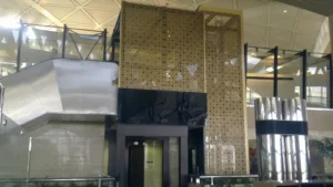 Interior of a terminal at King Khalid International Airport in Riyadh with metal structures and decorative panels