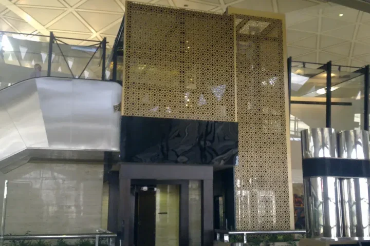 Interior of a terminal at King Khalid International Airport in Riyadh with metal structures and decorative panels