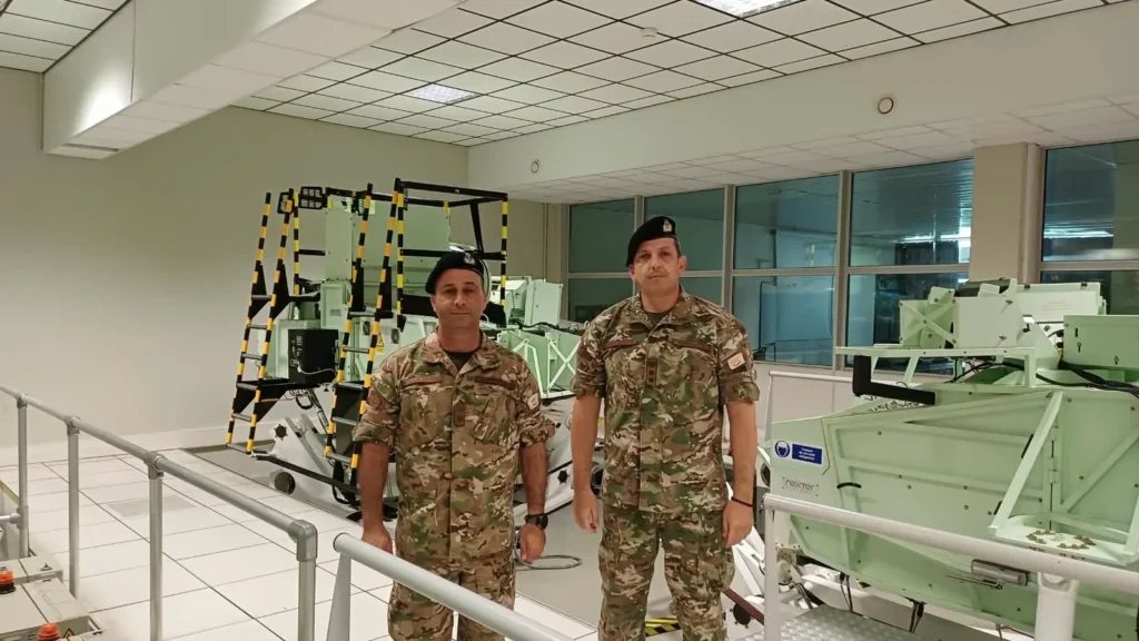 Armoured officers of the Cyprus National Guard standing in front of simulators at the Cavalry School in Saumur