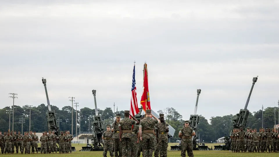 Marines salute the colors during the redesignation ceremony of 1st Battalion, 10th Marines at Camp Lejeune