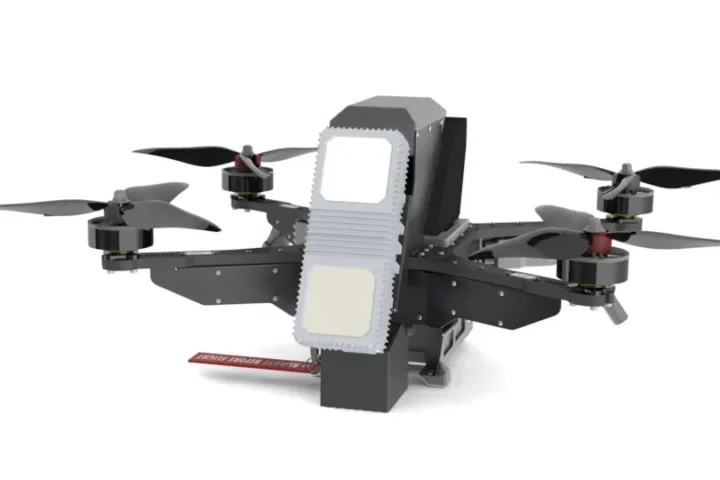Computer rendering of a quadcopter interceptor drone with a radar module mounted on its front, shown against a white background