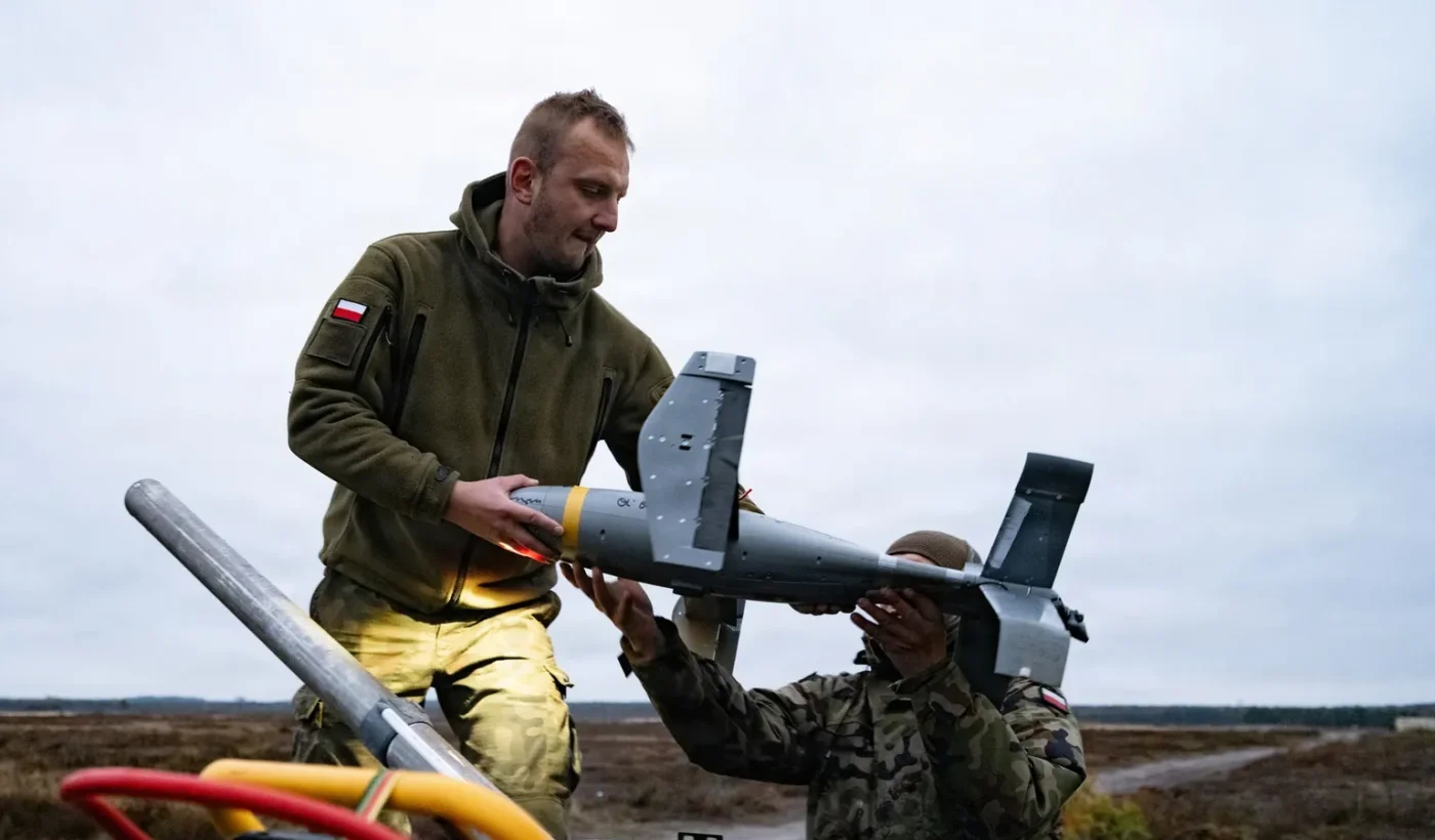 Polish soldiers loading an interceptor drone onto a launcher during counter-drone training near Lipa, Poland