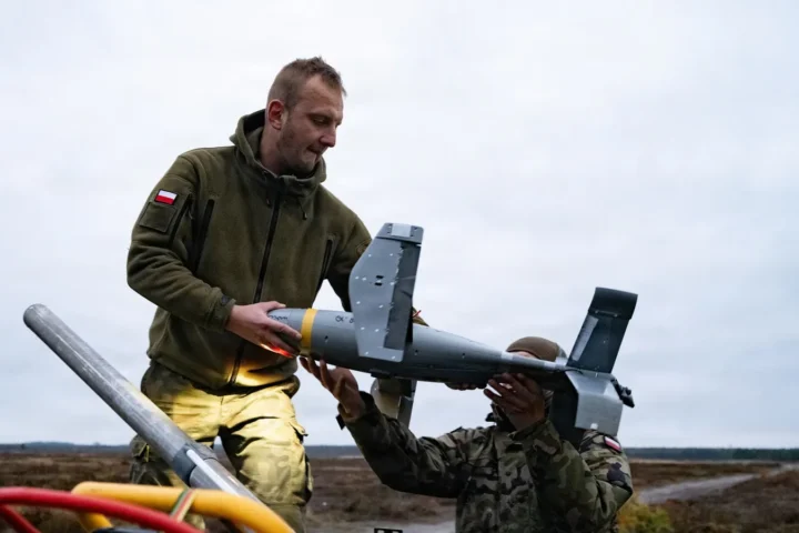 Polish soldiers loading an interceptor drone onto a launcher during counter-drone training near Lipa, Poland