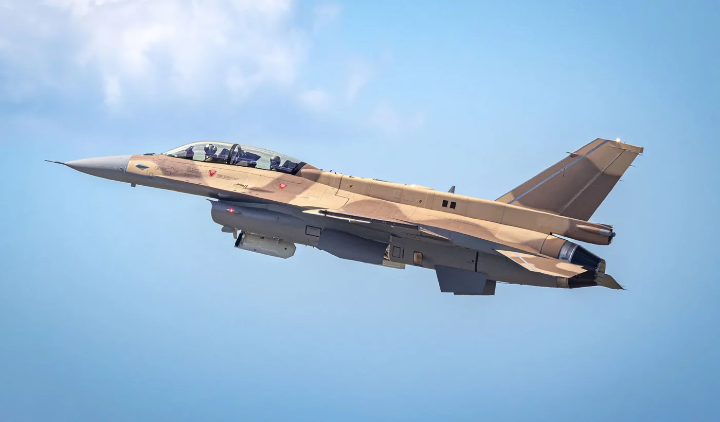 A two-seat F-16 Block 72 for the Royal Moroccan Air Force in desert camouflage climbing against a blue sky