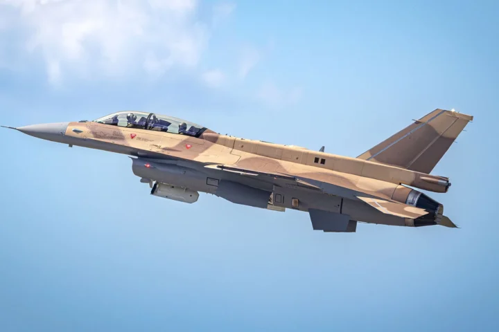 A two-seat F-16 Block 72 for the Royal Moroccan Air Force in desert camouflage climbing against a blue sky