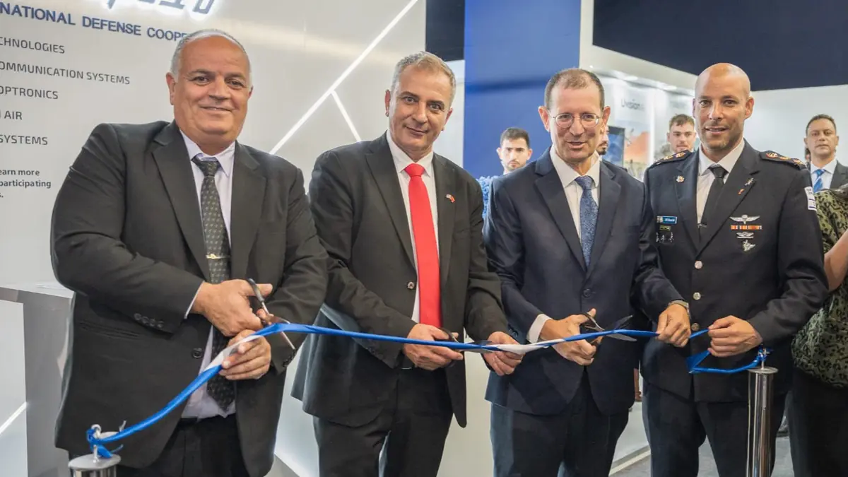 Four men cut a blue ribbon at the opening of the Israeli national defence pavilion at the Marrakech Airshow