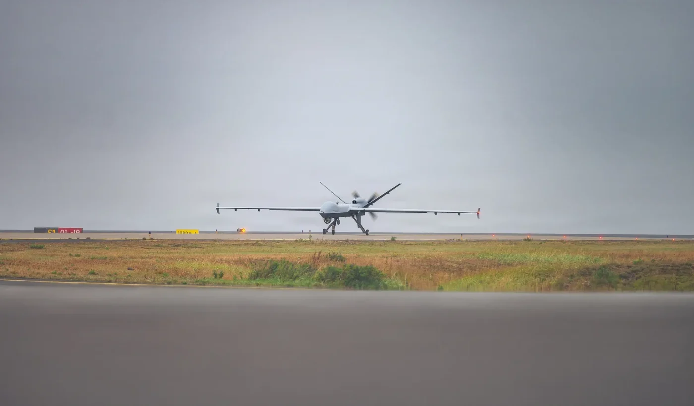 A US Air Force MQ-9 Reaper taxiing on a runway at Keflavik Air Base, Iceland, under an overcast sky