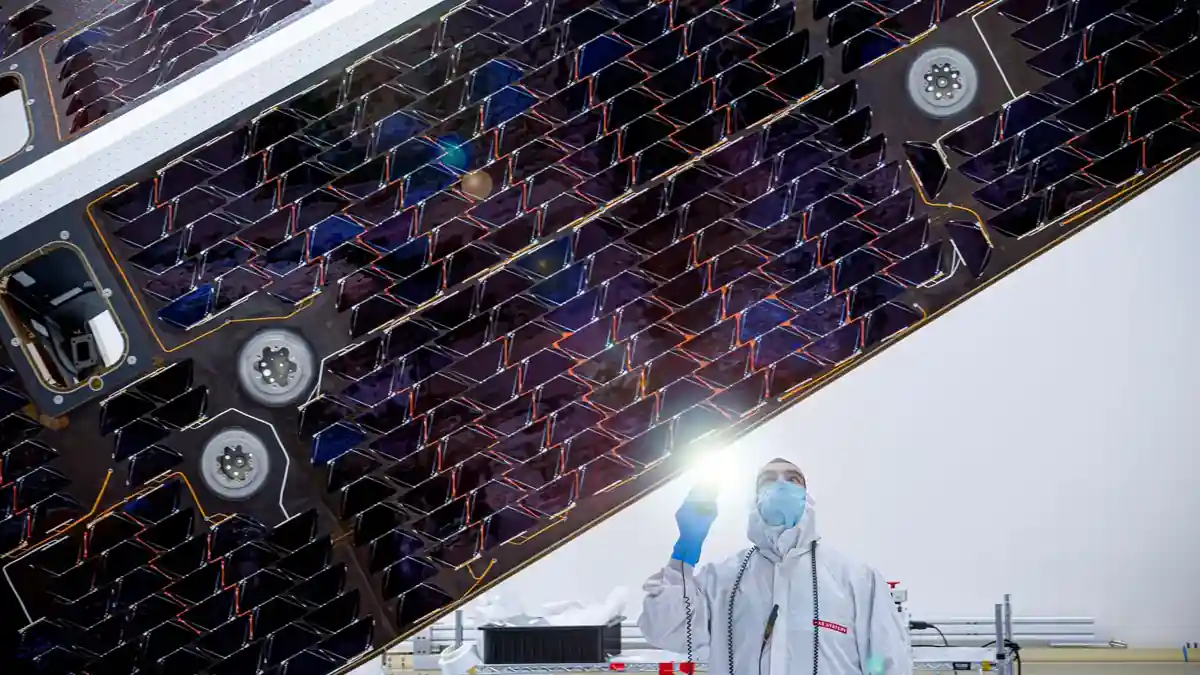 A technician inspects the solar cells of the NEO Surveyor sunshade