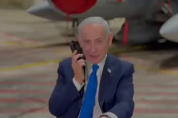 Israeli Prime Minister Benjamin Netanyahu on the phone with US President Donald Trump in a hangar with fighter aircraft