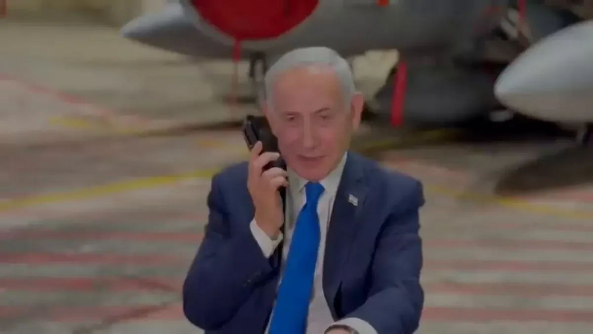 Israeli Prime Minister Benjamin Netanyahu on the phone with US President Donald Trump in a hangar with fighter aircraft