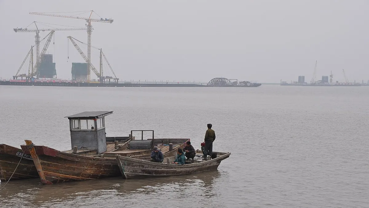 The New Yalu River Bridge under construction in June 2012, seen from the river near Dandong