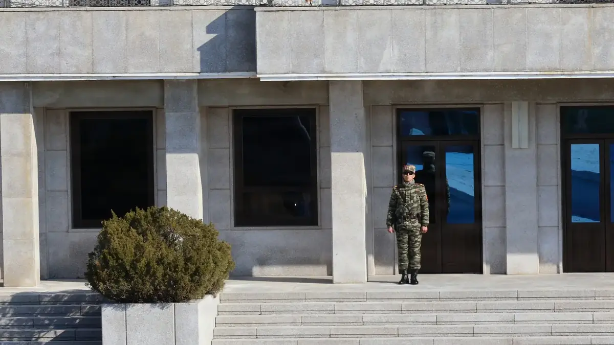 A North Korean soldier standing on the northern side of the Military Demarcation Line at Panmunjom