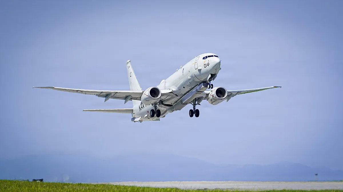 A P-8A Poseidon maritime patrol aircraft taking off from a runway