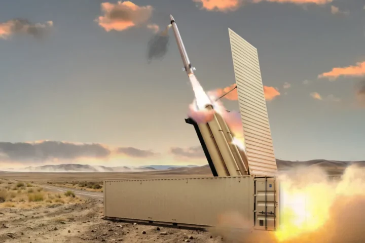 A computer rendering of the PAC-3 Edge interceptor missile leaving a containerised launcher in a desert landscape, with flame and dust at the base
