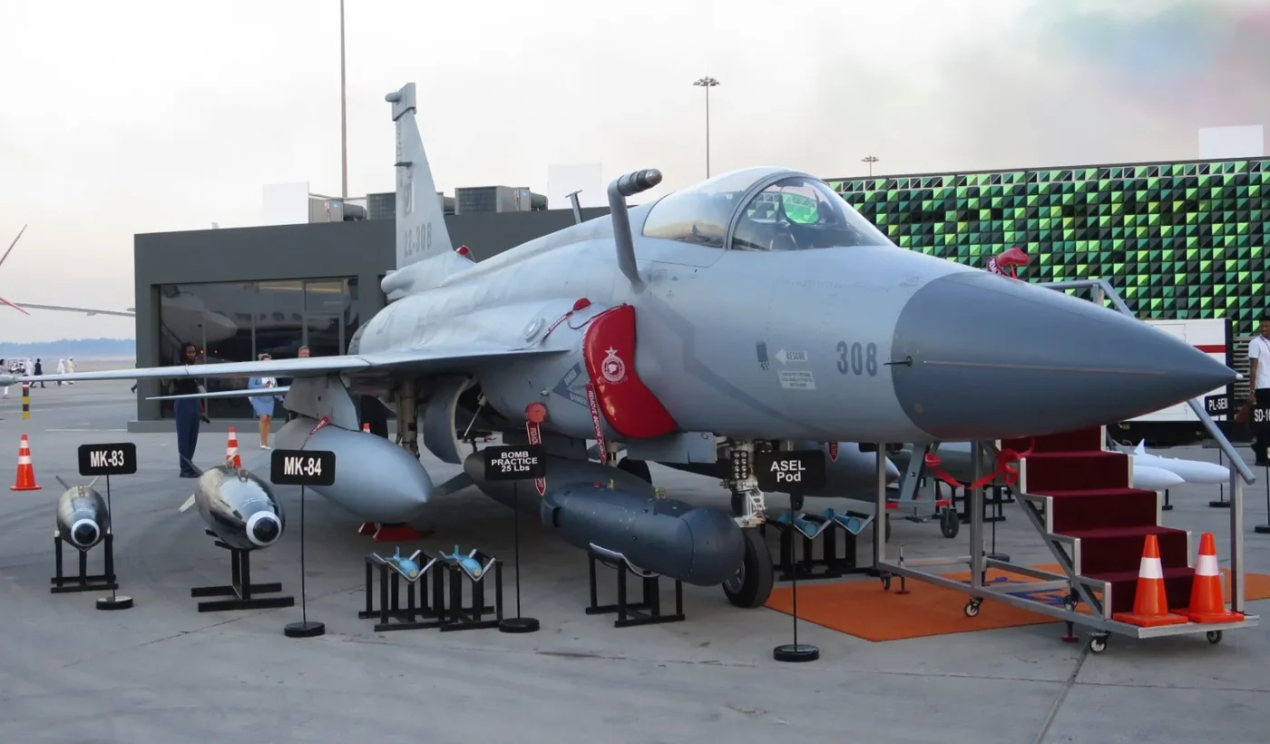 A Pakistan Air Force JF-17 Thunder Block III fighter jet on display on the apron with bombs and pods in front of it