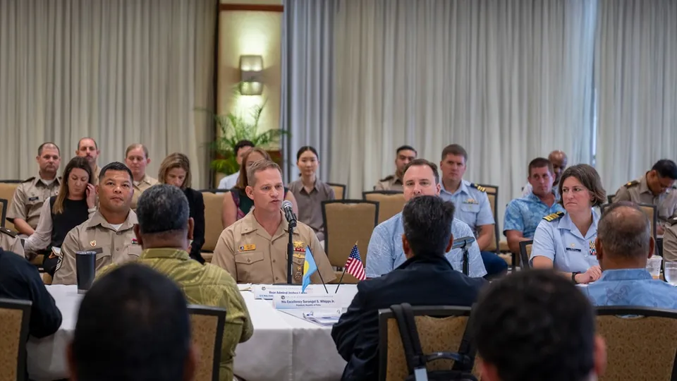 Rear Adm. Joshua Lasky speaking at the table during the U.S.-Palau Joint Committee Meeting in Honolulu