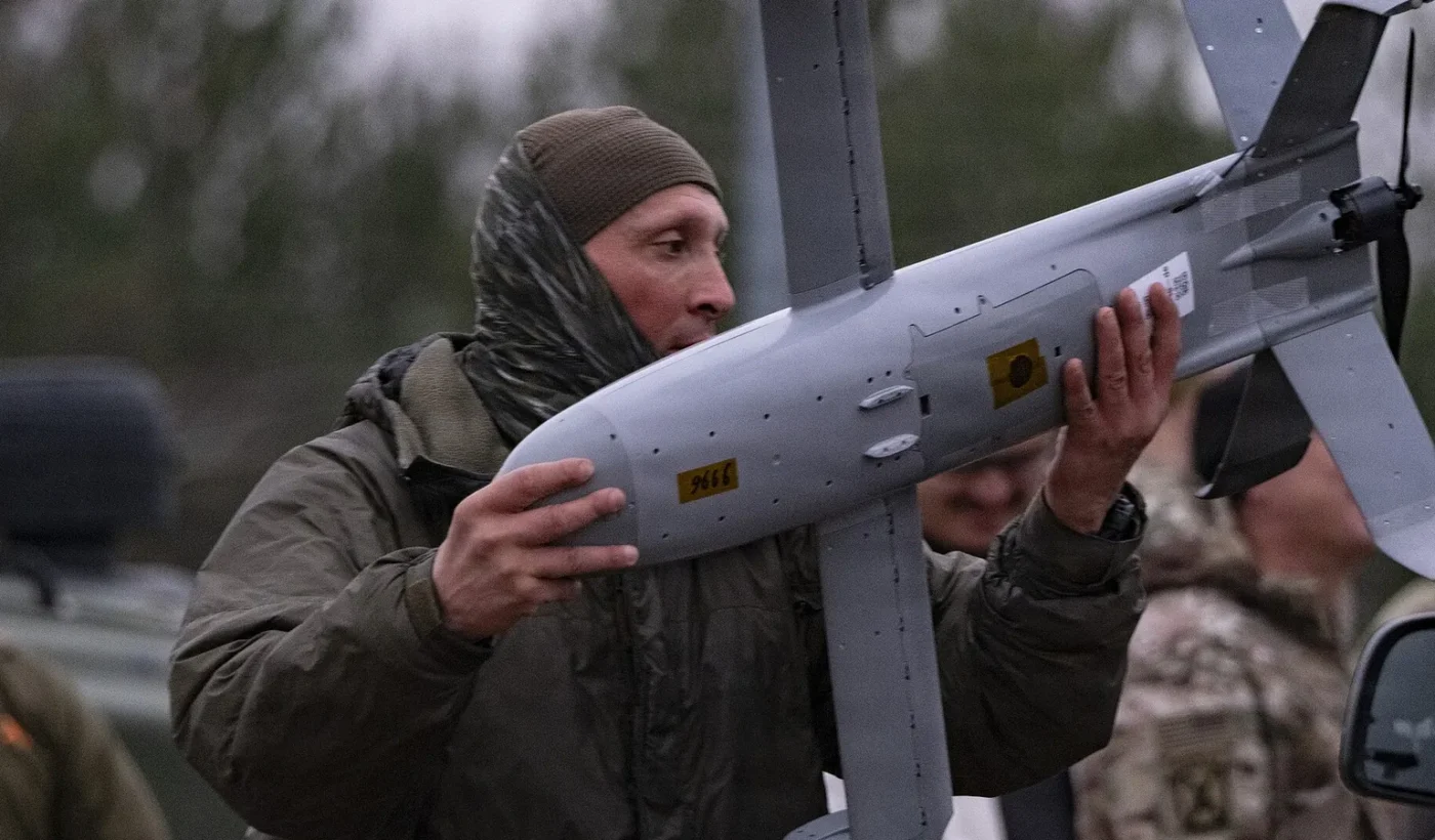 A Polish soldier carrying a Surveyor interceptor drone of the Merops counter-drone system near Lipa, Poland