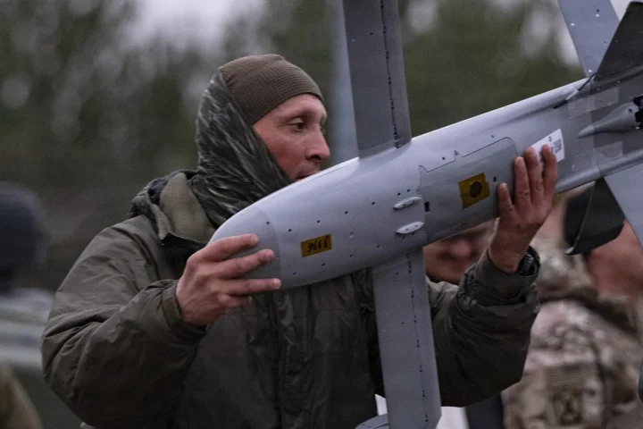 A Polish soldier carrying a Surveyor interceptor drone of the Merops counter-drone system near Lipa, Poland