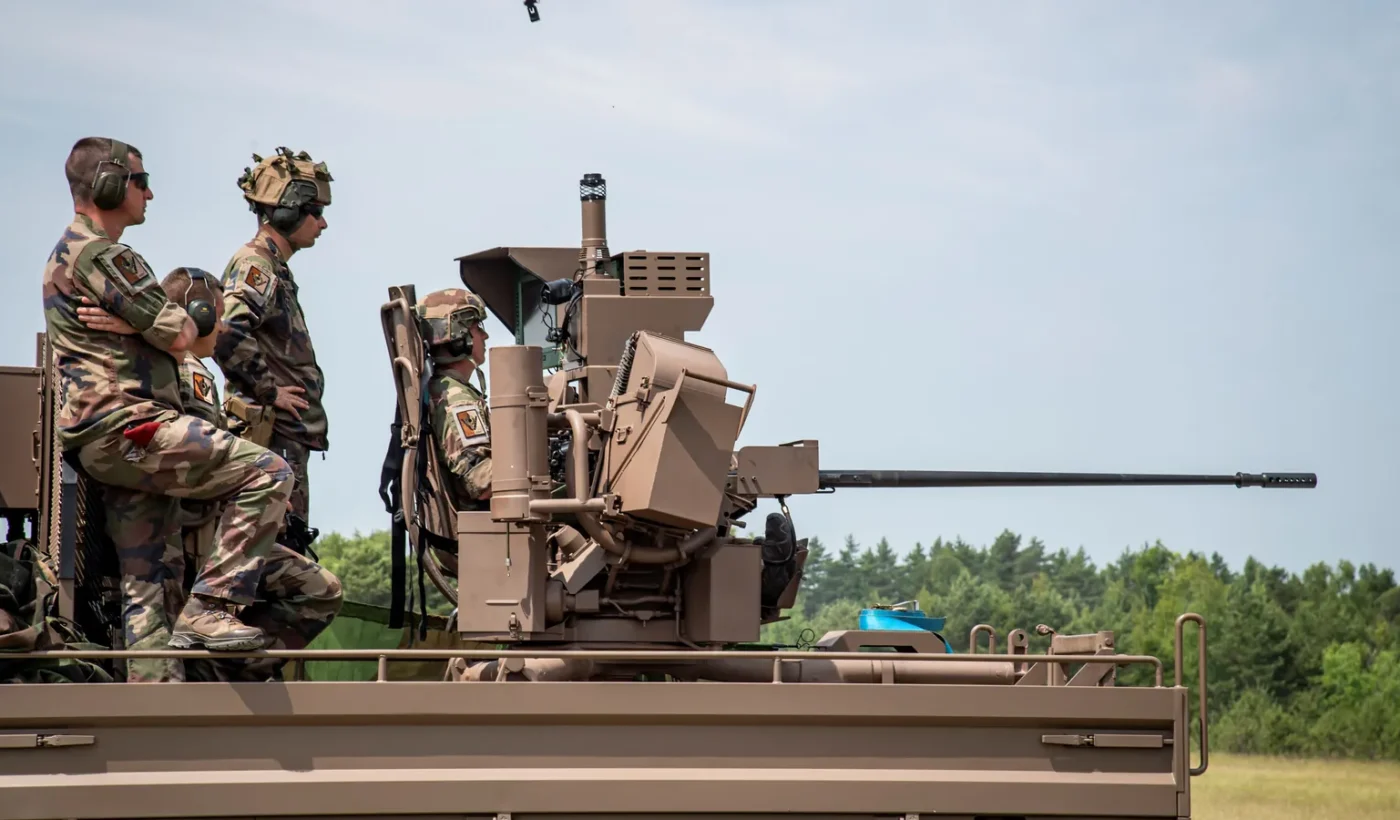 French soldiers beside the 20 mm gun of the Proteus counter-drone system, mounted on the bed of a TRM 2000 truck, during a firing session