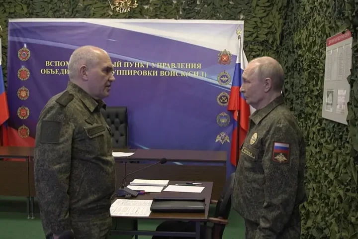 Vladimir Putin talking with a Russian military officer at an auxiliary command post of the Joint Force