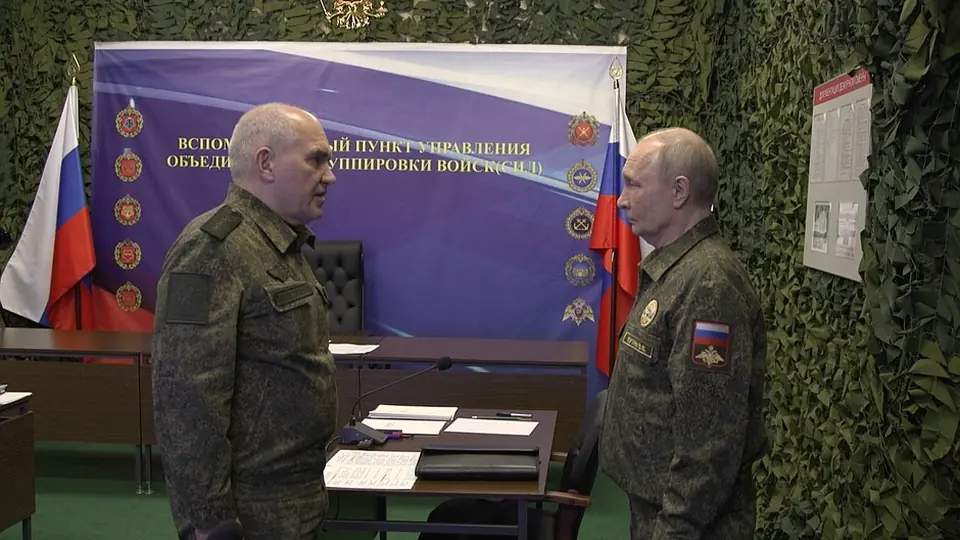 Vladimir Putin talking with a Russian military officer at an auxiliary command post of the Joint Force