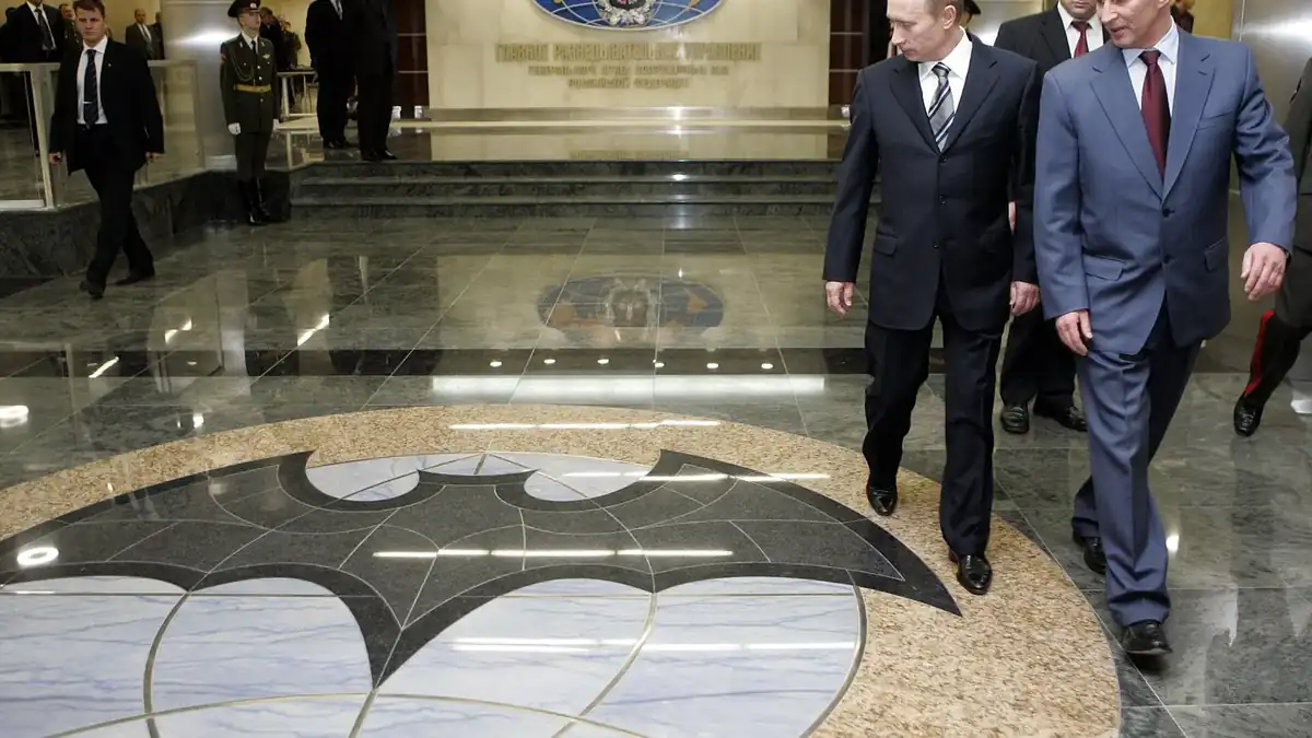 Vladimir Putin walking through the lobby of the new GRU headquarters during its opening