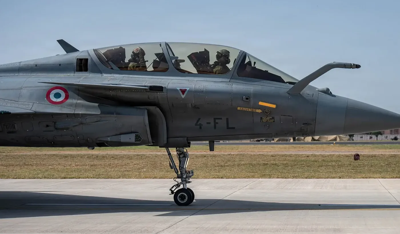 A two-seat Rafale B of the French Air and Space Force taxis with its crew in the cockpit