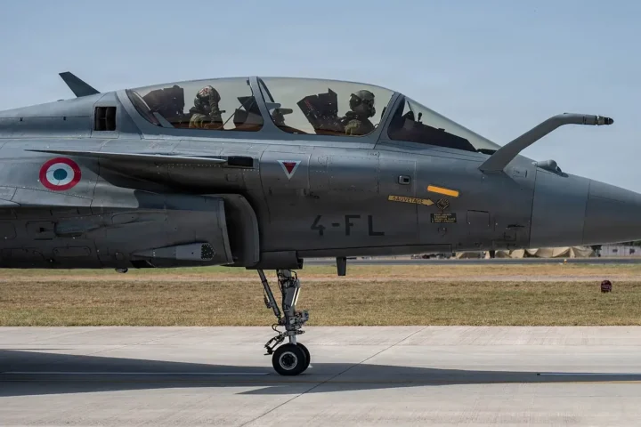 A two-seat Rafale B of the French Air and Space Force taxis with its crew in the cockpit