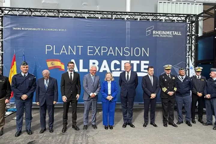 Officials and military officers pose in front of a banner reading Plant Expansion Albacete at the Rheinmetall Expal Munitions site