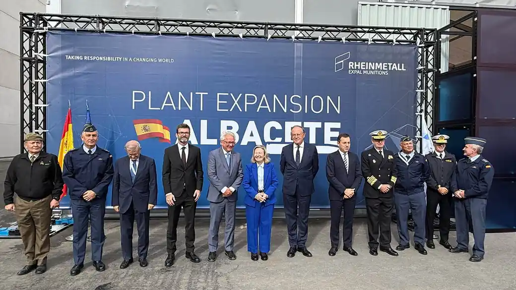 Officials and military officers pose in front of a banner reading Plant Expansion Albacete at the Rheinmetall Expal Munitions site