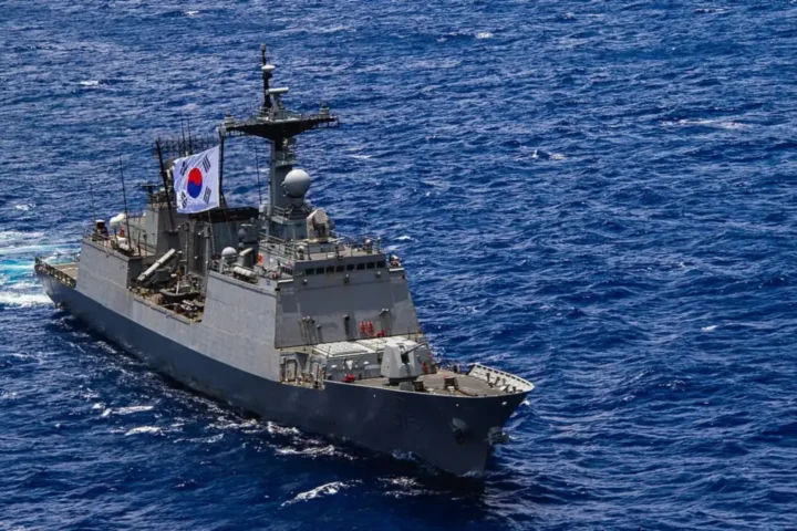 A grey destroyer sailing on the ocean