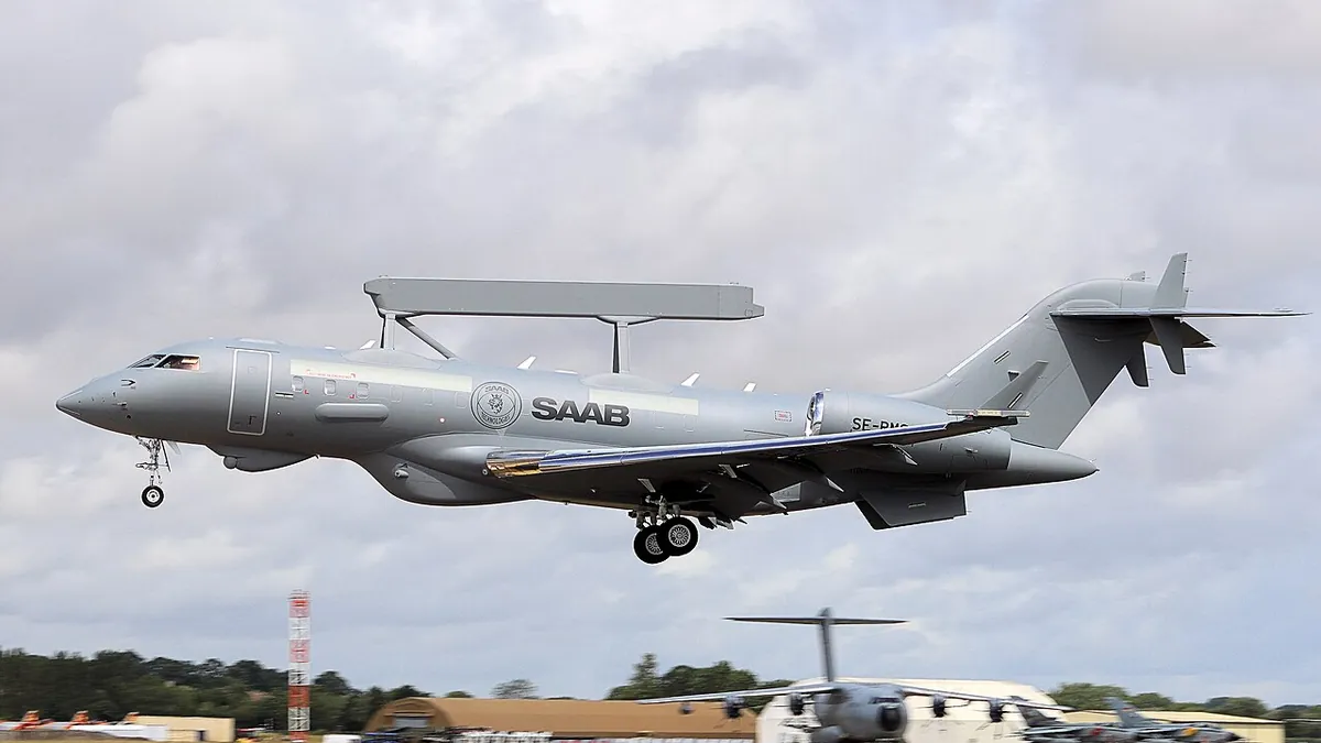 A Saab GlobalEye airborne early warning aircraft with its radar bar on the fuselage landing at an air show