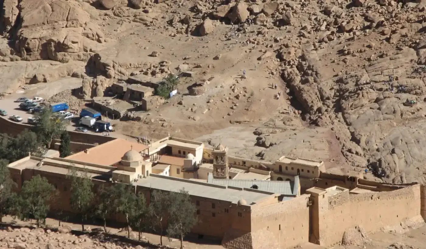 Aerial view of the walls and buildings of Saint Catherine’s Monastery at the foot of Mount Sinai in morning light