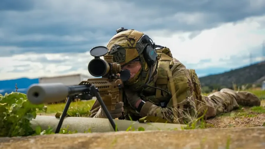 A Special Forces sniper in a firing position with the SAKO TRG M10, bipod and suppressor