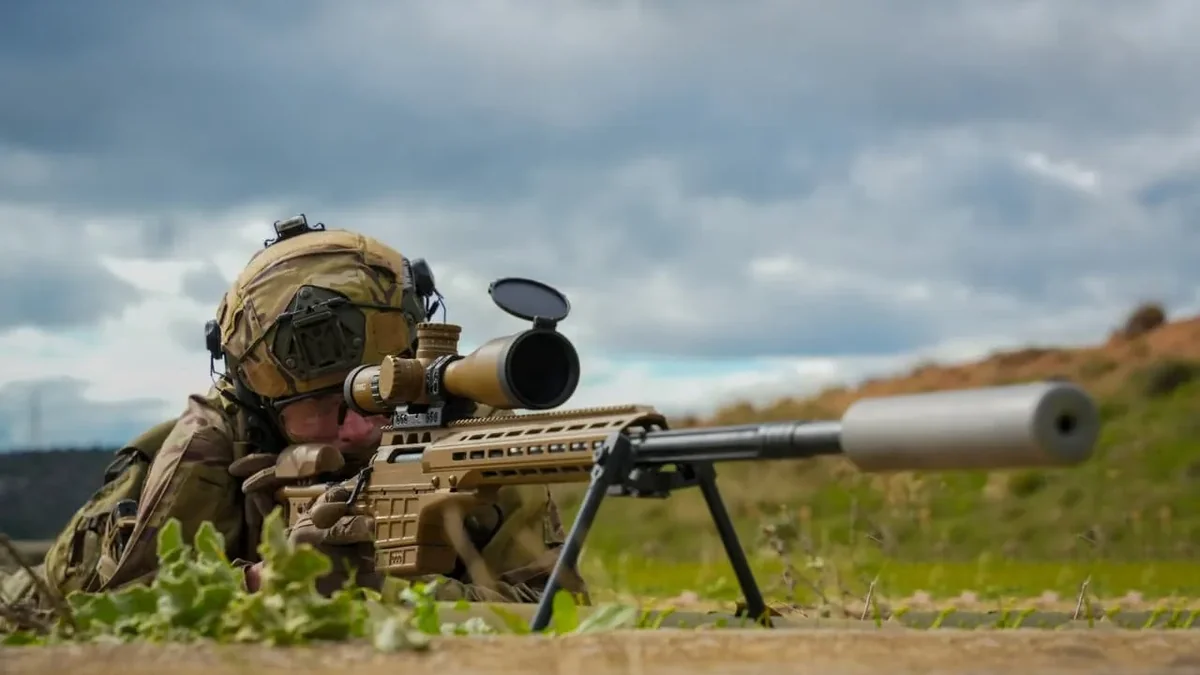 A Hellenic Army Special Forces sniper aiming a SAKO TRG M10 rifle with a suppressor