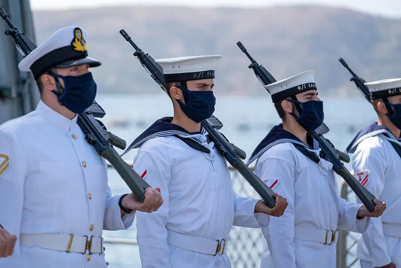 Hellenic Navy sailors in dress whites aboard the frigate Salamis during a 2020 visit