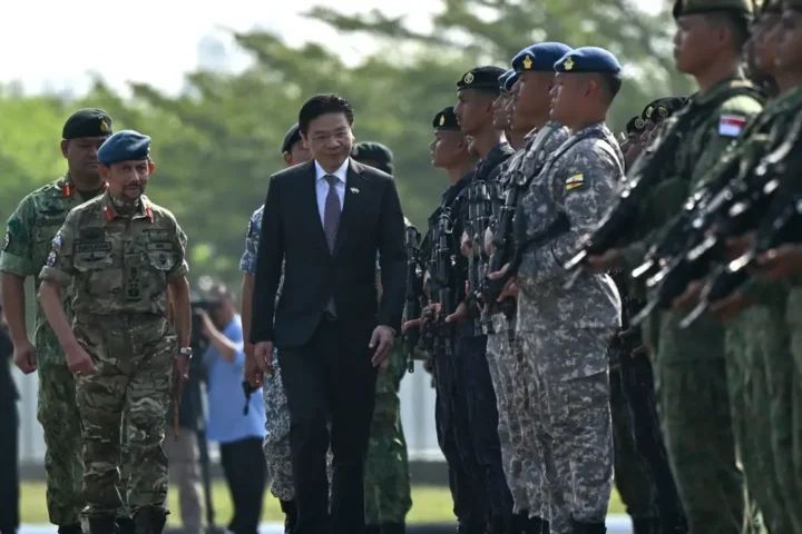 Singapore Prime Minister Lawrence Wong inspects a guard of Singaporean and Bruneian troops at the Joint Parade