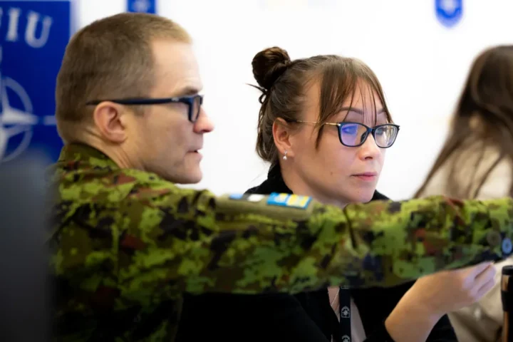Estonian Defence Forces and NATO Force Integration Unit personnel working at a desk during exercise Steadfast Duel 26