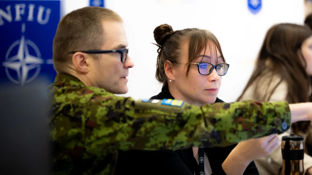 Estonian Defence Forces and NATO Force Integration Unit personnel working at a desk during exercise Steadfast Duel 26