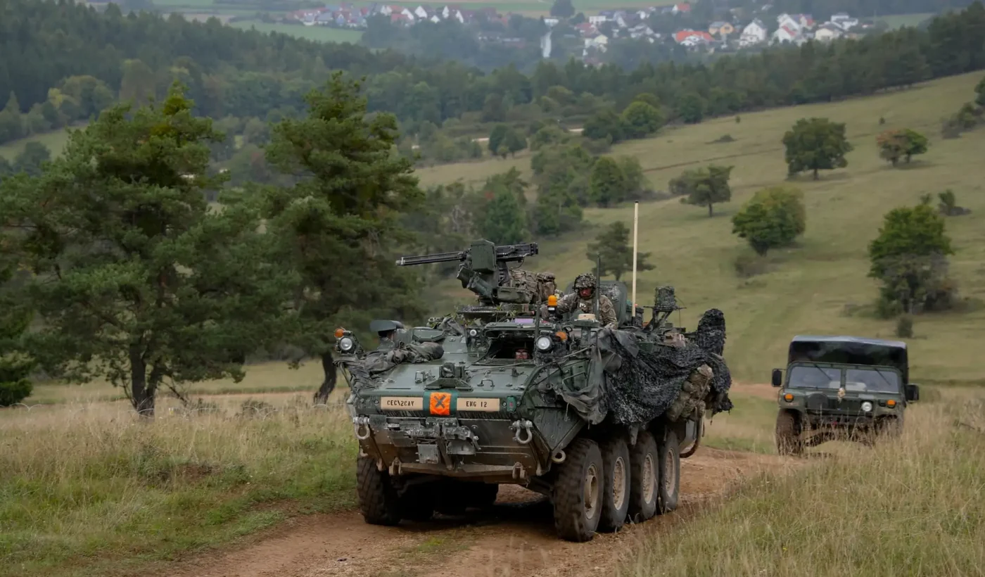 A Stryker of the US Army’s 2nd Cavalry Regiment with camouflage netting on a dirt track during exercise Saber Junction 25 at Hohenfels, Germany
