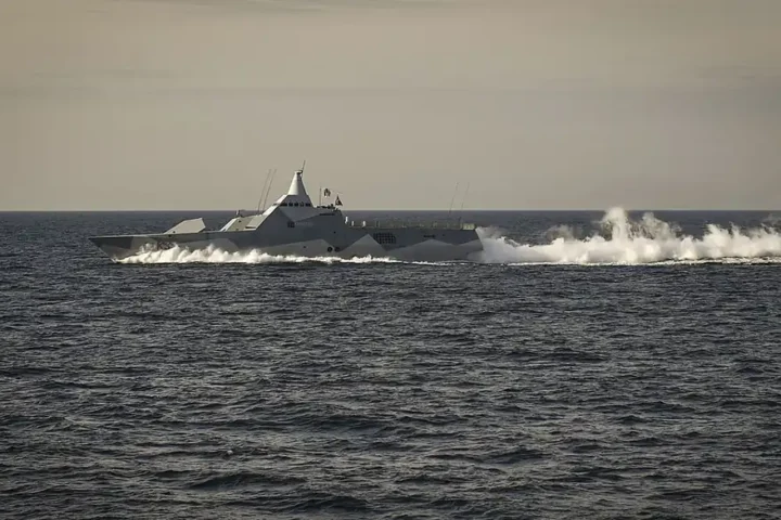 A Swedish Visby-class corvette moving fast through the Baltic Sea, trailing spray (file photo)