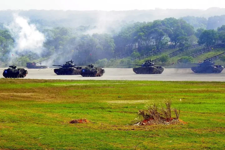 CM-11 tanks and CM-21A armoured personnel carriers of the Taiwanese army assaulting across open ground in an exercise