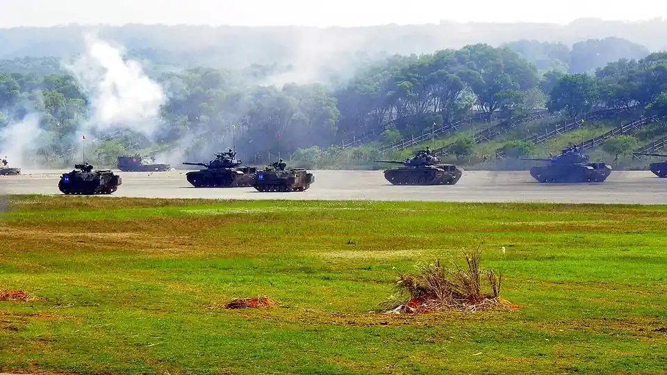 CM-11 tanks and CM-21A armoured vehicles of the Taiwanese army advancing across open ground during an exercise