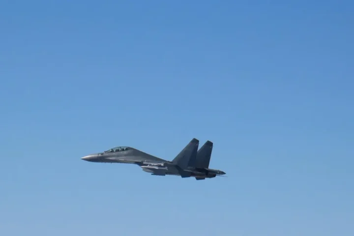 A Chinese PLA Air Force J-16 fighter in flight against a clear sky