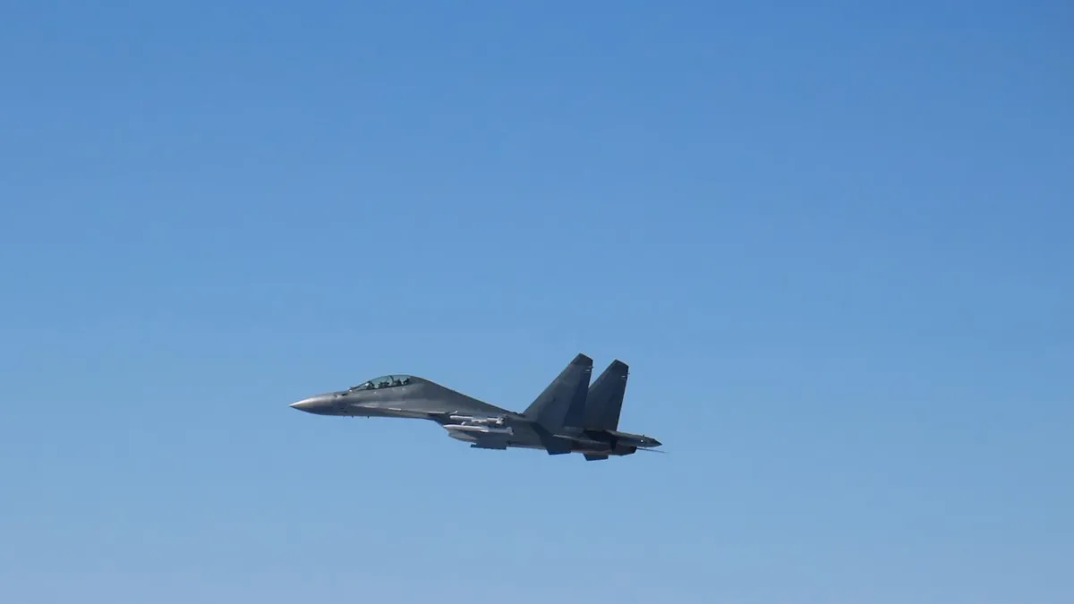 A Chinese PLA Air Force J-16 fighter in flight against a clear sky