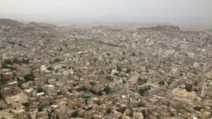 Aerial view of the dense city of Taiz in Yemen seen from Al-Qahira Castle under a hazy sky